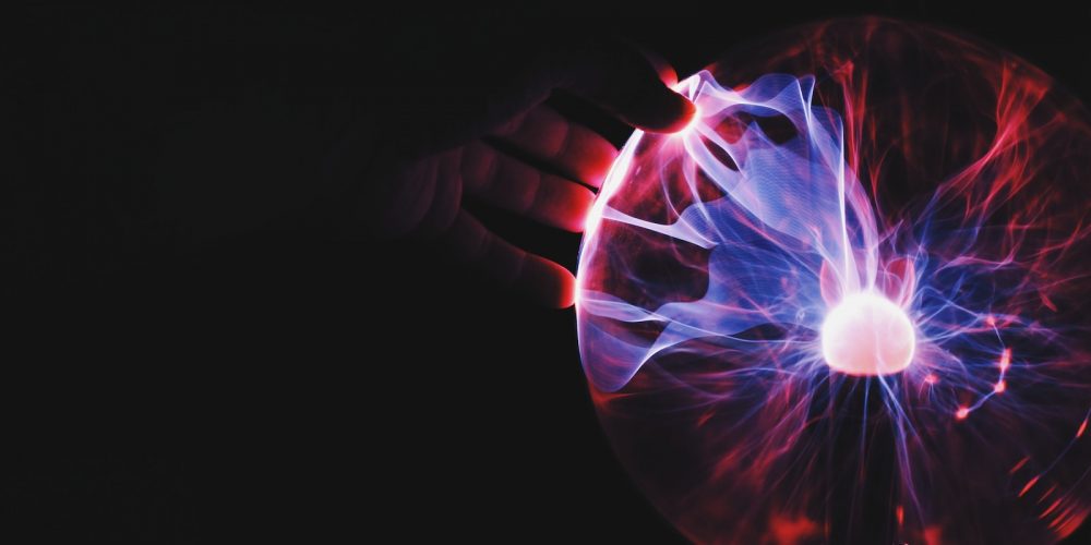 human hand holding plasma ball